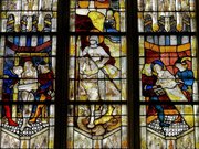 Verrière de la vie de saint Georges : à gauche, les flancs du saint sont brûlés par deux bourreaux, à droite, il est scié en deux, au centre, saint Georges triomphe du dragon